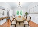Formal dining room with a chandelier, hardwood floors, and a window with views of the outdoors at 763 Old Paper Mill Se Dr, Marietta, GA 30067