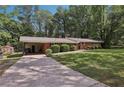 Well-maintained home with a long driveway, attached carport, and a storage shed in the backyard at 112 Pioneer Trail, Cartersville, GA 30121