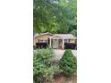 Inviting home exterior with a cozy front porch and manicured landscaping at 2030 Carr Rd, Conyers, GA 30012
