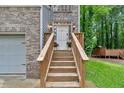 Close up view of the front door, with flower boxes and a wood porch and stairway at 2766 Stonecreek Se Rd, Smyrna, GA 30080