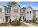 Attractive townhome exterior with brick accents, gray siding, and a welcoming landscaped front yard at 324 Navigator Ln, Mcdonough, GA 30253
