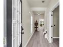 Inviting entryway features hardwood floors, neutral walls, and view of the living room at 355 Pintail Ct, Suwanee, GA 30024