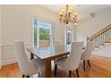 Dining room features hardwood floors, chandelier, and a large window with natural light at 1003 Pearl Ne Pt, Sandy Springs, GA 30328