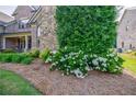 Beautiful landscaping with flowering shrubs and mature trees at 468 Scott Farm Dr, Powder Springs, GA 30127
