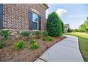 Beautiful landscaping with flowers and stone accents along the sidewalk at 468 Scott Farm Dr, Powder Springs, GA 30127