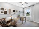 Bright home office featuring neutral walls, large windows, and comfortable seating with design package samples at 470 Village Ln, Fairburn, GA 30213