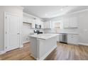 Modern kitchen featuring stainless steel appliances, island, and hardwood floors at 470 Village Ln, Fairburn, GA 30213