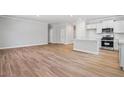 Inviting living space featuring hardwood floors, a modern kitchen, and open floor plan at 470 Village Ln, Fairburn, GA 30213