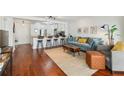 Bright living room and kitchen with hardwood floors and a breakfast bar with stool seating at 620 Peachtree Ne St # 403, Atlanta, GA 30308