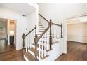 Elegant staircase features white railings, wood steps, and hardwood flooring, seamlessly connecting levels at 1198 Larson Sw Ln, Marietta, GA 30064