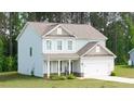 Well-maintained home exterior with green lawn, white trim, and a covered front porch at 20 Tarpley Way, Covington, GA 30016