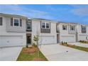 Newly built townhouses featuring attached garages and individual driveways at 305 Heavenly Hollow Pl, Mcdonough, GA 30253