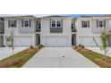 Modern townhomes boasting individual driveways and white painted brick at 305 Heavenly Hollow Pl, Mcdonough, GA 30253