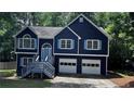 Attractive two-story home featuring a blue exterior with light shutters and trim, accented by a well-maintained front yard at 4790 Brandon Acres Ln, Buford, GA 30519