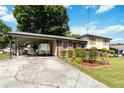A home with a carport and a well maintained lawn and roses at 5791 Cobbrook Dr, Ellenwood, GA 30294