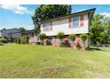A charming house with brick and vinyl siding and a green front yard at 5791 Cobbrook Dr, Ellenwood, GA 30294