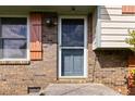 A close-up view of the home's front door with brick facade and decorative shutters at 5791 Cobbrook Dr, Ellenwood, GA 30294