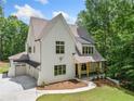 Striking two-story home with a two-car garage and covered front porch with wood columns at 2585 Hickory Rd, Canton, GA 30115