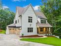 Beautiful two-story white brick home with attached garage and well-manicured lawn at 2585 Hickory Rd, Canton, GA 30115