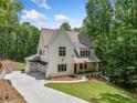 Stunning white brick home with a two-car garage and inviting covered front porch at 2585 Hickory Rd, Canton, GA 30115