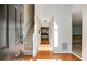 Inviting foyer with hardwood floors, a staircase, and ample natural light streaming through the doorway at 4150 Soaring Dr, Douglasville, GA 30135