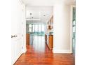 Open-concept kitchen with stone counters, wood cabinets, stainless appliances, island, and expansive windows with panoramic views at 4561 Olde Perimeter Way # 2102, Atlanta, GA 30346