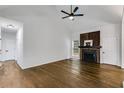 Vaulted ceiling living room boasts a cozy fireplace, gleaming hardwood floors, and ample natural light at 130 Opal Ln, Carrollton, GA 30116