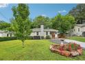 Exterior view of a cozy home with a lush green yard, a quaint front porch, and ample parking space at 1605 Wellswood Se Dr, Atlanta, GA 30315