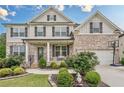 Beautiful two-story home with a brick and siding exterior, landscaped front yard, and attached garage at 285 Turtle Rock Pl, Acworth, GA 30101