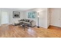 Cozy living room featuring hardwood floors, large window, and comfortable seating area at 3137 Buford Ne Hwy # 11, Brookhaven, GA 30329