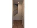 Light and bright hallway with hardwood floors and a staircase with iron railings at 707 Dodd N Ln # 164, Buford, GA 30518