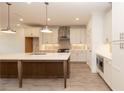 Eat-in kitchen with a large central island, pendant lighting, and stainless appliances at 707 Dodd N Ln # 164, Buford, GA 30518