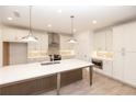 Bright eat-in kitchen featuring a large central island with pendant lighting and modern appliances at 707 Dodd N Ln # 164, Buford, GA 30518