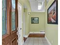 Inviting foyer with tiled floor, decorative glass front door, and natural light from skylight at 789 Concord Sw Rd, Smyrna, GA 30082