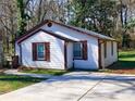 Picture perfect exterior showing the white siding and brown trim at 141 Nathan Rd, Atlanta, GA 30331