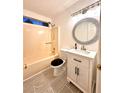 Bright half bathroom with vanity, decorative mirror, and shower-tub combo at 3793 Mays Sw Ct, Atlanta, GA 30331