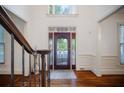 Elegant foyer with decorative glass door and hardwood flooring at 385 Guildhall Grv, Johns Creek, GA 30022