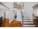 Spacious foyer with hardwood staircase and trim details at 385 Guildhall Grv, Johns Creek, GA 30022
