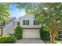 Charming two-story home features a well-manicured lawn, attached garage, and classic architectural details at 5712 Grande River Rd, Atlanta, GA 30349