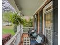 Cozy front porch with wicker chairs, a small table, and a view of the neighborhood at 710 Bentgrass Ct, Dacula, GA 30019