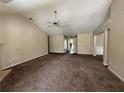Expansive living room featuring neutral walls, vaulted ceilings with a ceiling fan, and plush carpet at 124 Sparkling Spring Trl, Mcdonough, GA 30252