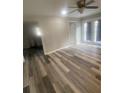 Bright living room features ceiling fan, door to outside, and modern hardwood floors at 1905 Robinhill Ct, Tucker, GA 30084