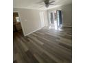 Bright living room features wood-look flooring and modern ceiling fan at 1905 Robinhill Ct, Tucker, GA 30084