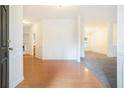 Bright entryway with hardwood floors leading to a carpeted area, and lovely interior details at 2717 High Creek Run, Dacula, GA 30019