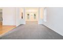 Spacious living room with neutral carpet, columns, and bright lighting at 2717 High Creek Run, Dacula, GA 30019