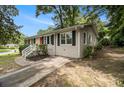 Well-maintained home featuring manicured landscaping and a concrete driveway at 3294 Renault Se Rd, Atlanta, GA 30354