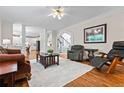Bright living room features hardwood floors, a ceiling fan, and an open layout with access to other areas at 3944 Blustery Ne Way, Marietta, GA 30066