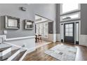 Elegant foyer with hardwood floors, a modern entry door, and decorative mirrors on the wall at 4045 Bridle Ridge Dr, Suwanee, GA 30024