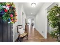 Inviting entryway featuring hardwood floors and a view into the living area at 5744 Cypress Bluff Ln, Hoschton, GA 30548