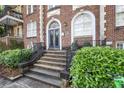 Building entrance featuring an arched doorway and manicured landscaping and staircase at 61 16Th Ne St # 4, Atlanta, GA 30309